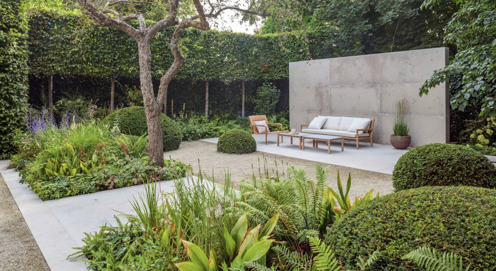 Porcelain paving with lush planted borders